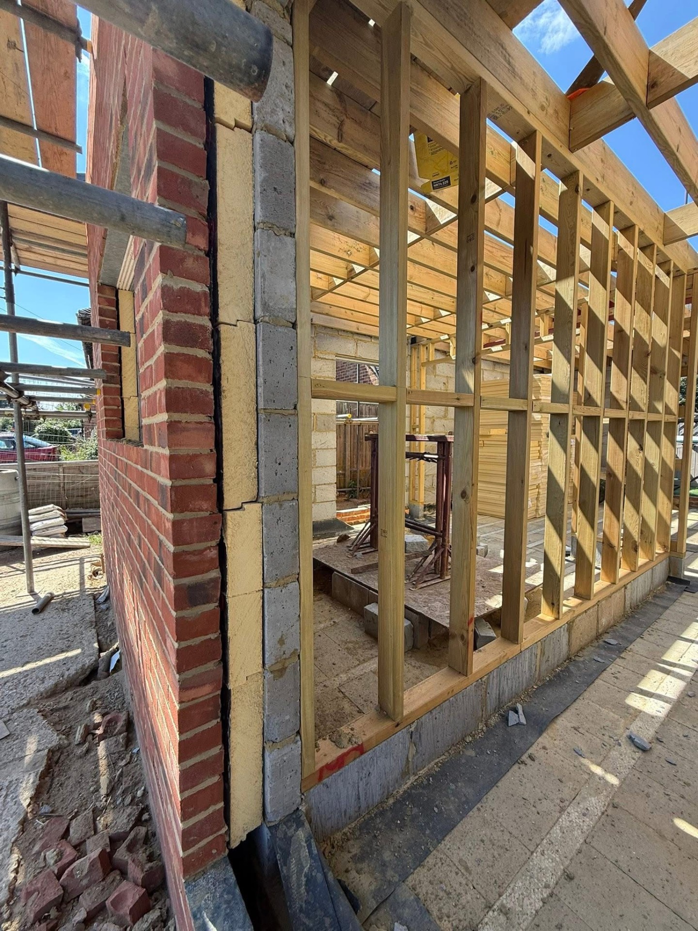 Close view of new build timber stud framing and brickwork detail by A Baker Construction West Sussex