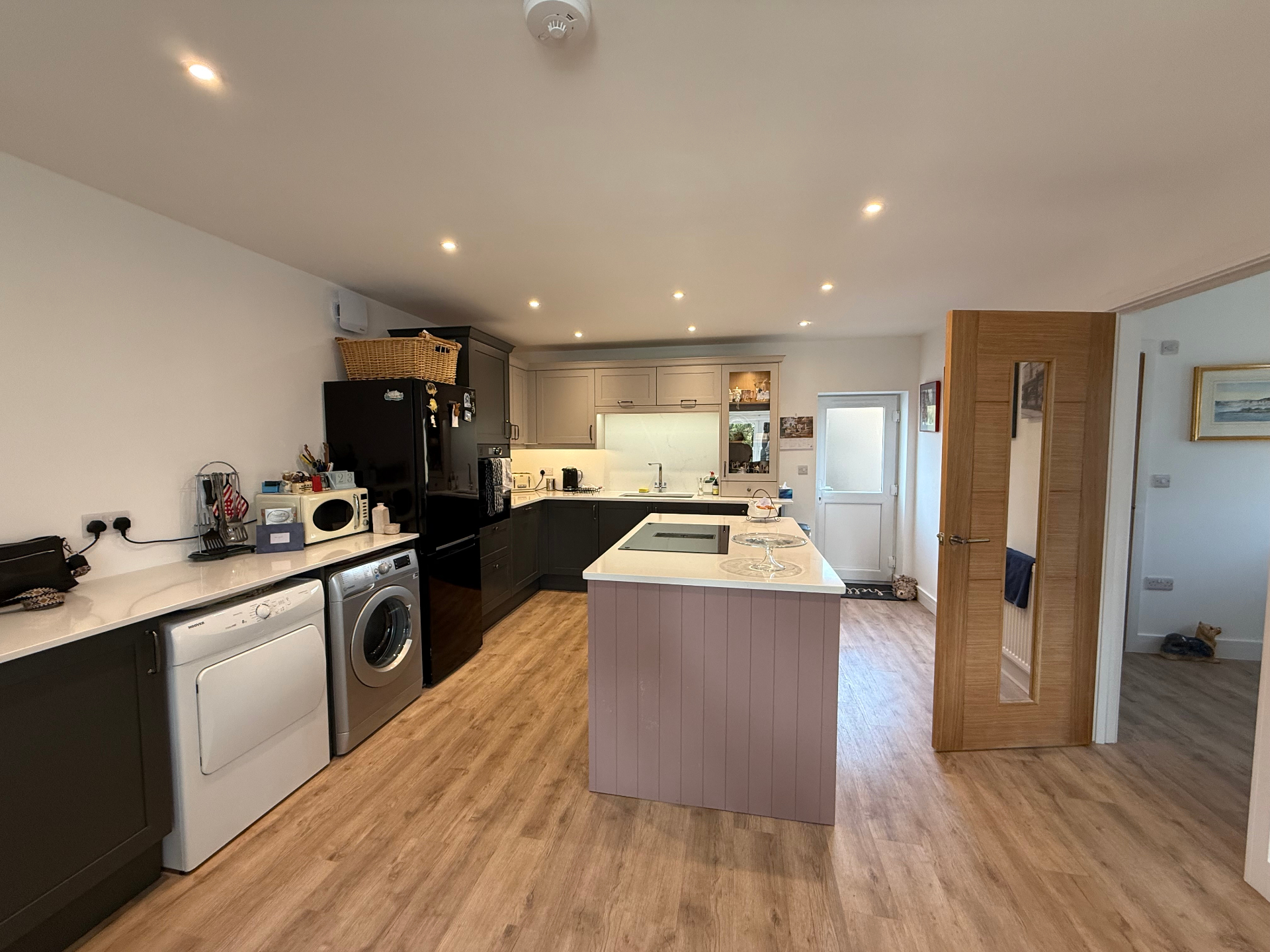 Finished new build kitchen with island and timber flooring by A Baker Construction West Sussex