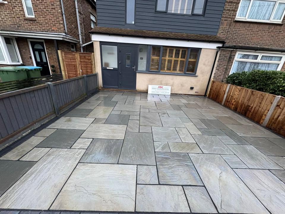 Indian sandstone paved driveway with charcoal border laid by A Baker Construction in West Sussex
