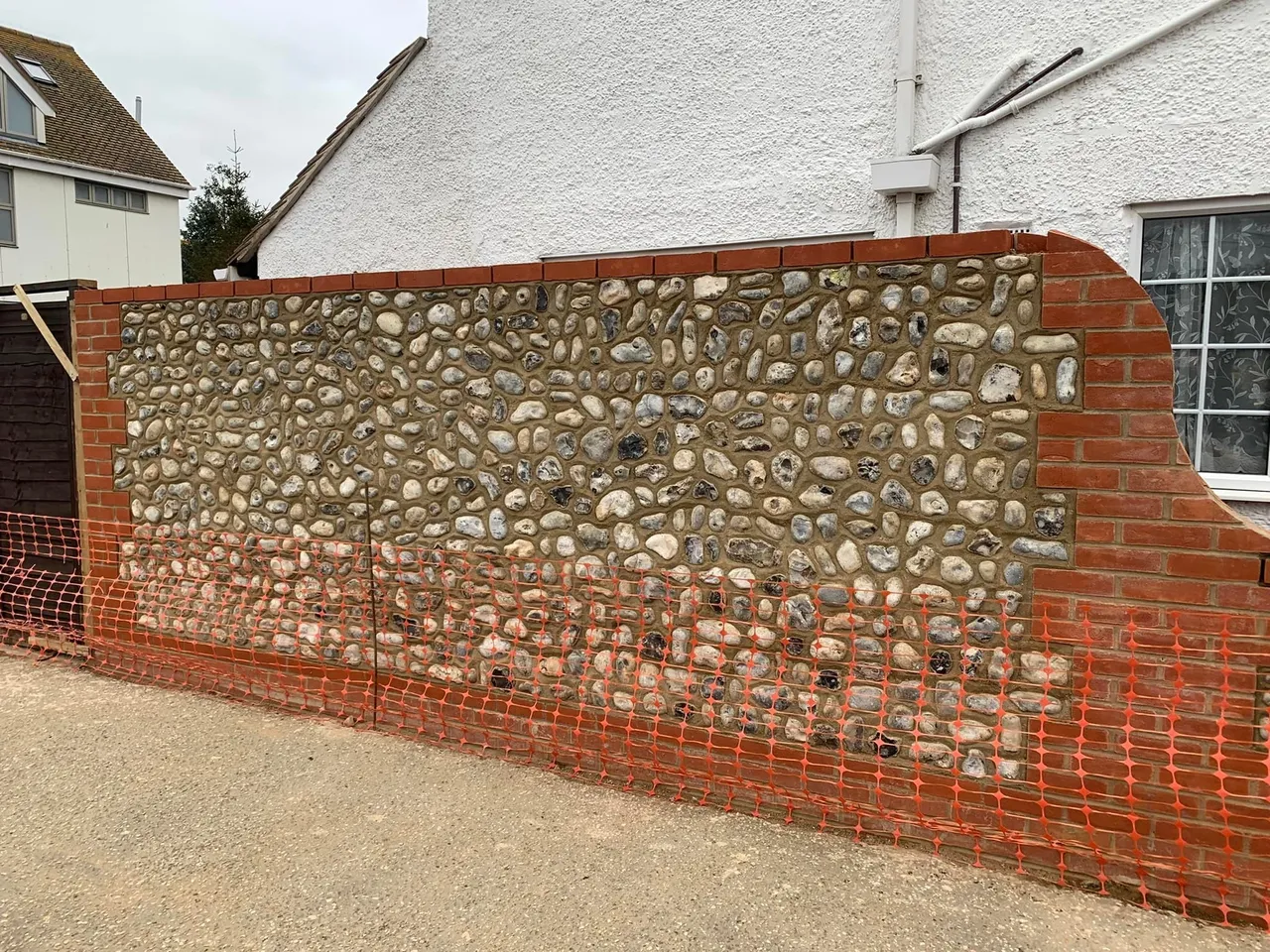 Flint wall with red brick detailing constructed by A Baker Construction & Son in West Sussex