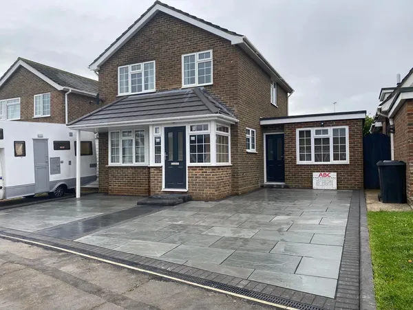 Three generations of the Baker family builders in front of a completed West Sussex home